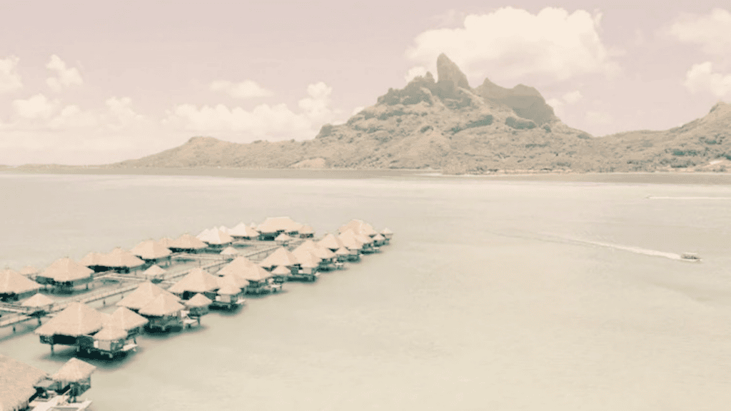 Bora Bora's iconic mountain peak rising above overwater bungalows