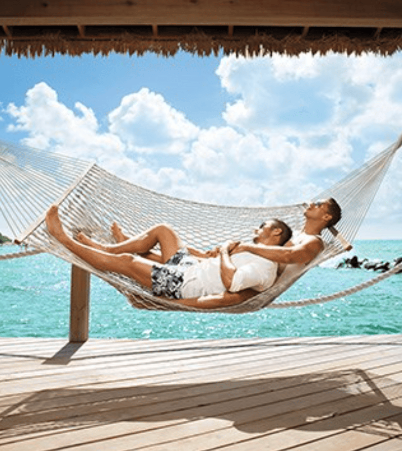 LGBTQ+ Couple relaxing in a cabana